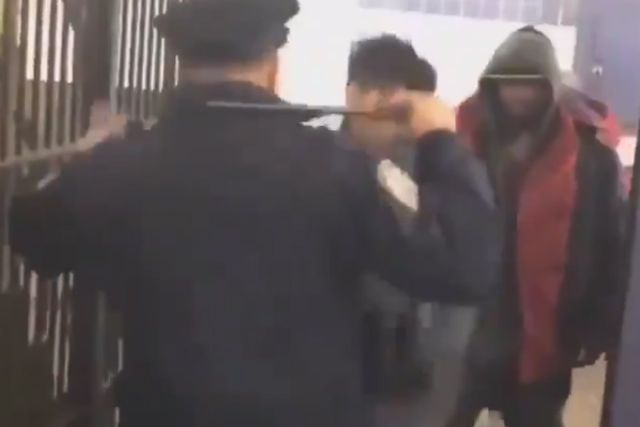 A screenshot from the video of the officer fending off attackers in the subway station.
